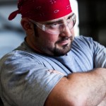 Close up of manual worker wearing safety glasses