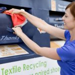 woman putting clothes in recycling bin