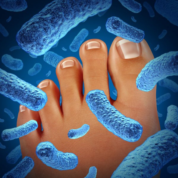 Image of foot with microbes to demonstrate how Cleansport NXT Technology destroys these microbes to eliminate odors caused by feet. 