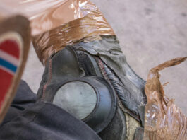 Ditch the Duct Tape: Time for a Workwear Overhaul Black boots with brown duct tape